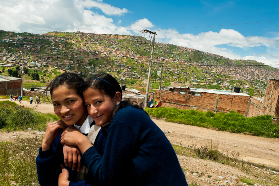 Young Colombian girls on the way home from school in the slum of Ciudad Bolívar in Bogota, Colombia.