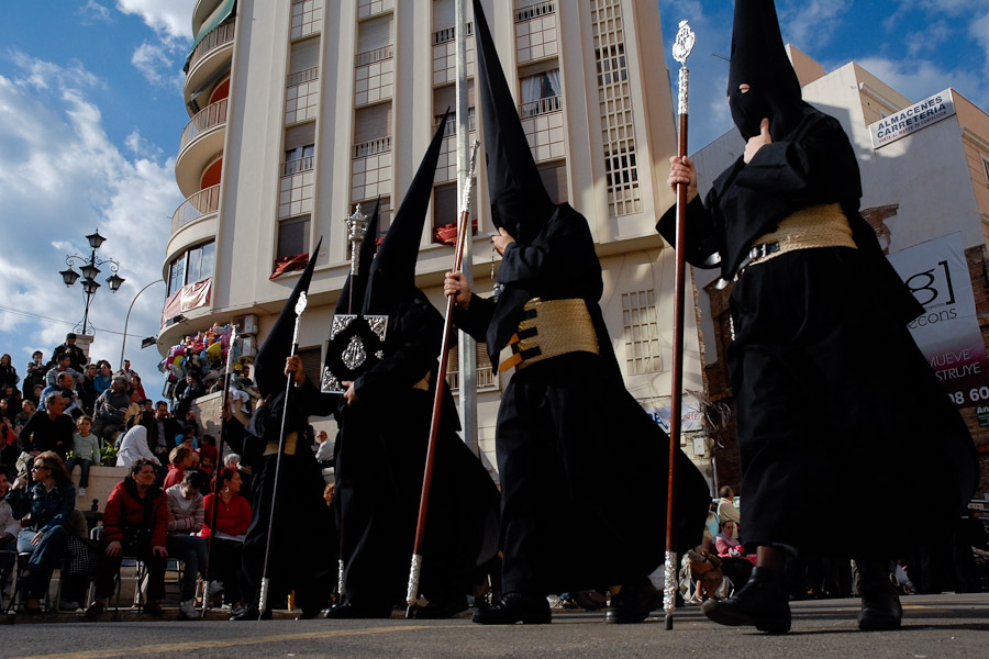 The penitential gown in the Spanish Holy Week is generally composed of a tunic and a hood with conical hat (capirote) used to mask the identity of the Nazareno.