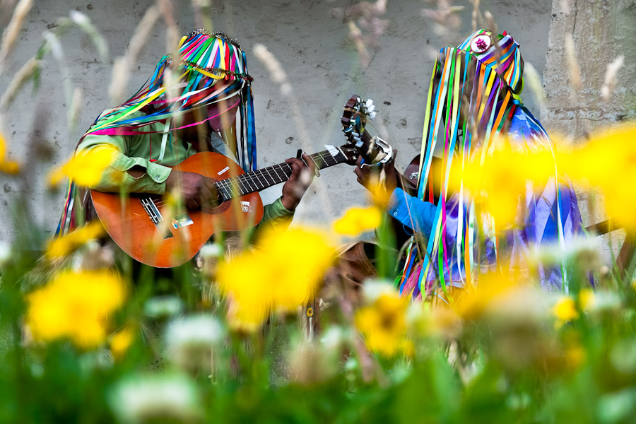 Indians, wearing colorful costumes, play guitars during the Inti Raymi celebration in Pesillo.