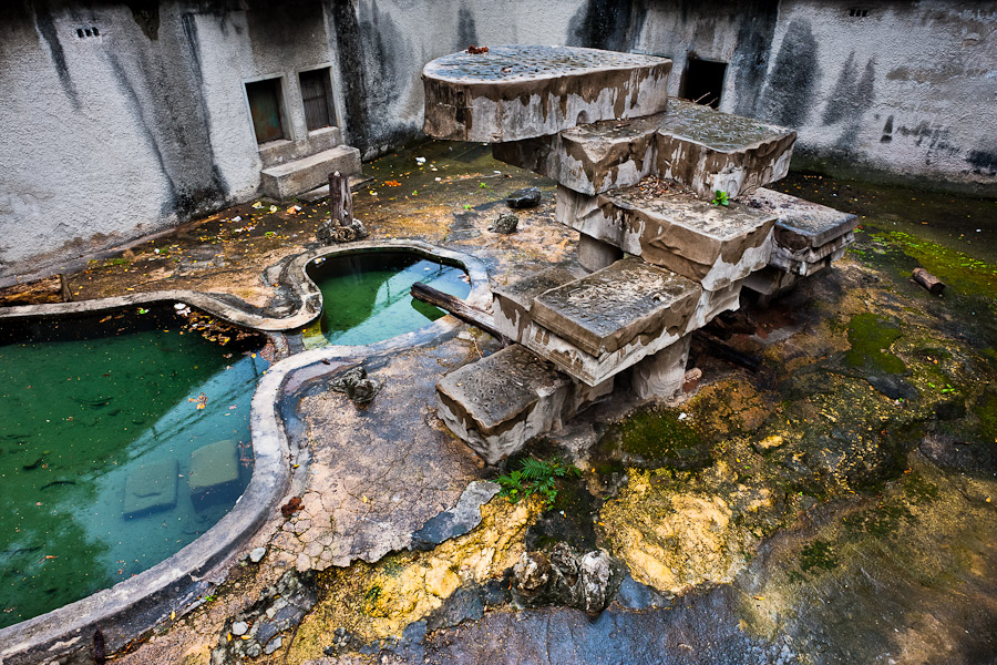 An empty and unmaintained concrete bear pit at the Havana Zoo.