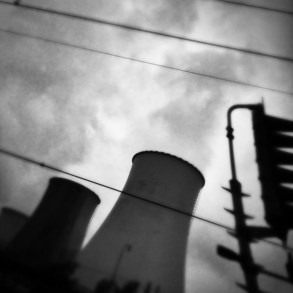 Cooling towers of the Prunéřov I coal-fired power plant seen from the train passing through the industrial area in the north of the Czech Republic.