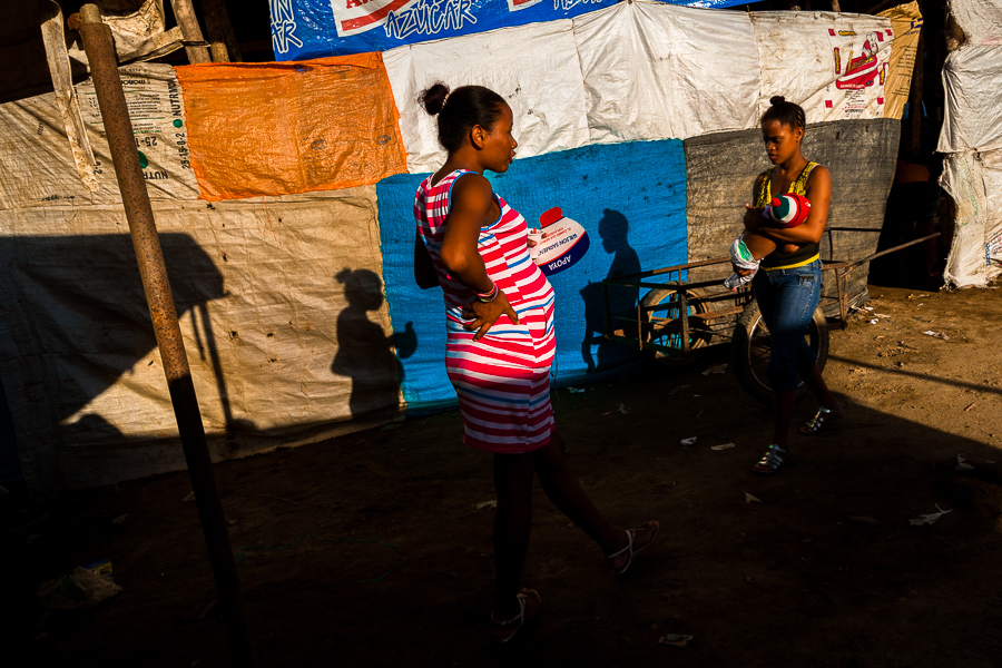 Young Colombian mothers walk around the arena of Corralejas, a rural bullfighting festival held in Soplaviento, Colombia.