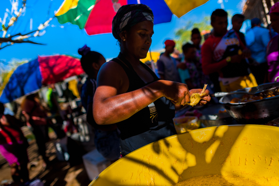 A Colombian woman prepares fried yuca dough rolls in front of the arena of Corralejas, a rural bullfighting festival held in Soplaviento, Colombia.