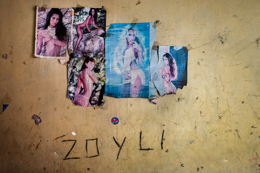 Crumpled posters of semi-nude models are seen taped to the scratched wall of a sexual service saloon in San Salvador, El Salvador.