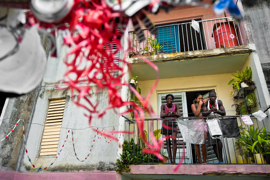 A Cuban family relax on the balcony in an apartment block in Abel Santamaría, a public housing suburb of Santiago de Cuba.