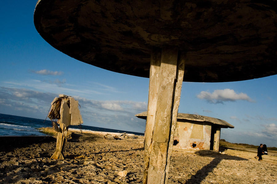 Cuban lovers sitting and embracing on the ruins of a devastated sea promenade during the sunset in Alamar, a huge public housing complex in the Eastern Havana, Cuba.