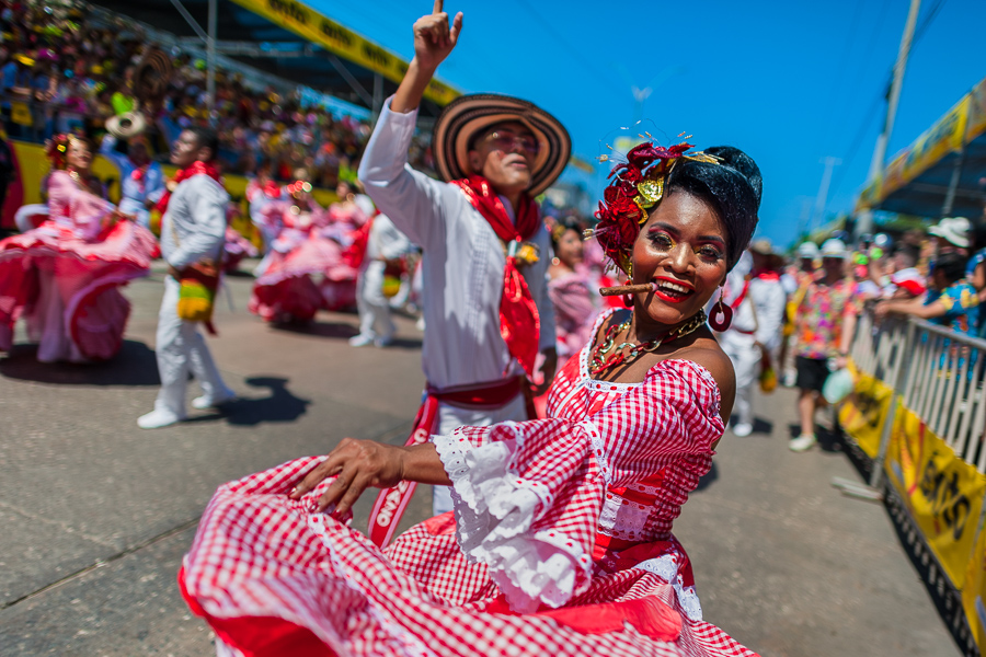 Afro-Colombian couples, wearing traditional cumbia outfits, dance the cumbia during the Batalla de Flores, the major parade of the Carnival in Barranquilla, Colombia.