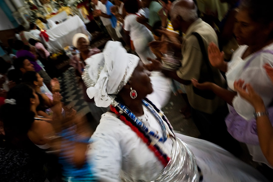 A Baiana woman performs the ritual dance in honor to Omolú, the Candomblé spirit syncretized with Saint Lazarus, inside the St. Lazarus church in Salvador, Bahia, Brazil.