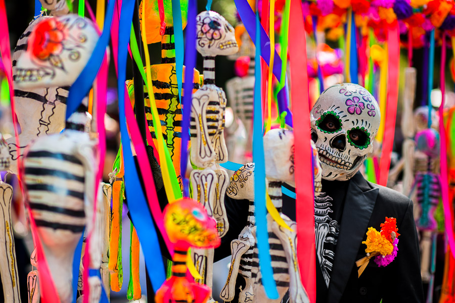 A Mexican man, dressed as skeleton (Calaca), walks through the town during the Day of the Dead parade in Mexico City, Mexico.