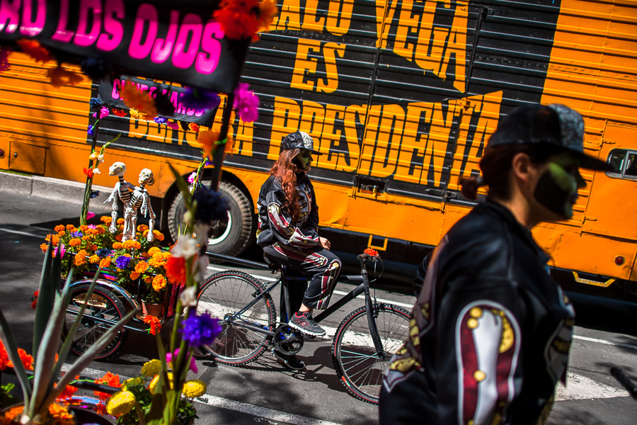 A Mexican girl, dressed as skeleton (Calaca), performs on a bicycle during the Day of the Dead celebrations in Mexico City, Mexico.