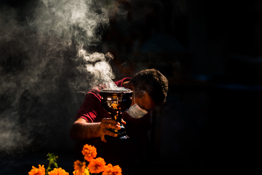 A Mexican man performs a ceremonial purification of a tomb during the Day of Dead celebrations in Tlapa de Comonfort, Guerrero, Mexico.