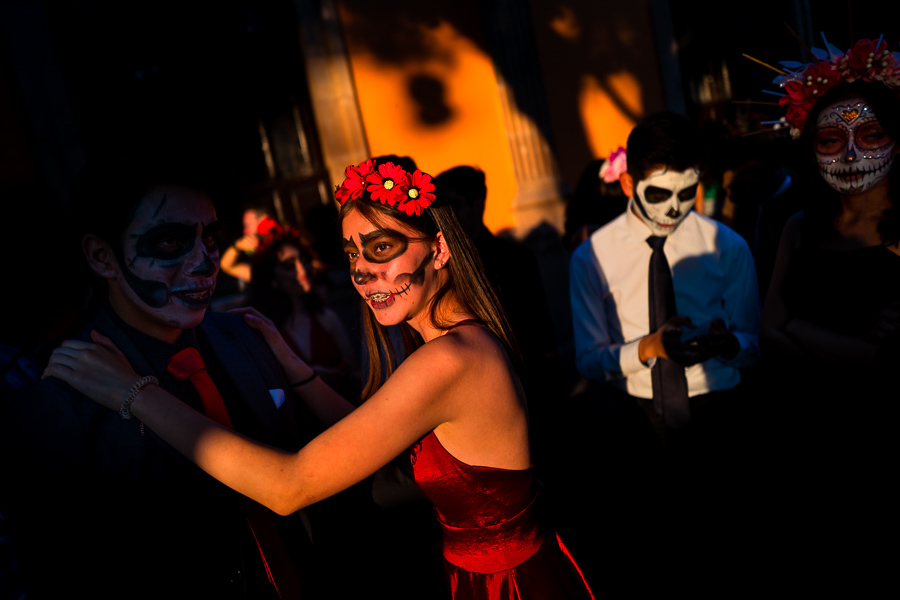 A young Mexican woman, dressed as La Catrina, and young Mexican men, dressed as Catrín, take part in the Day of the Dead celebrations in Morelia, Michoacán, Mexico.