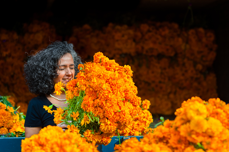 A Mexican woman smells a bunch of marigold flowers (Flor de Muertos) for the Day of the Dead celebrations in Mexico City, Mexico.