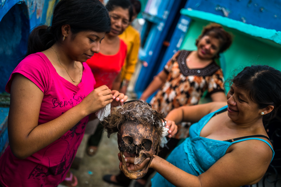 Mayan women take care of a dried-up scull of a deceased family member during the bone cleansing ritual at the cemetery in Pomuch, Mexico.