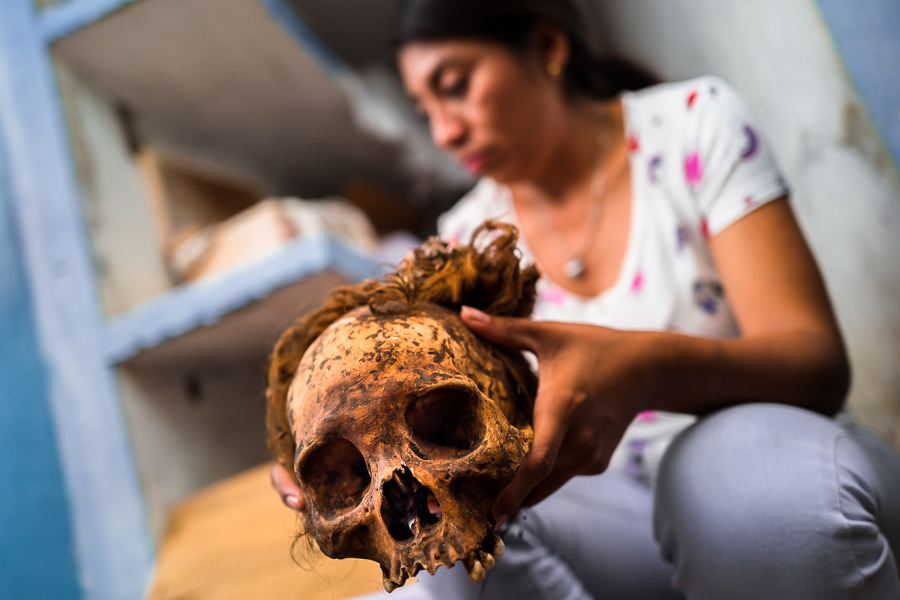 A Mayan woman holds a dried-up scull of her deceased grandmother during the Day of the Dead ritual at the cemetery in Pomuch, Mexico.
