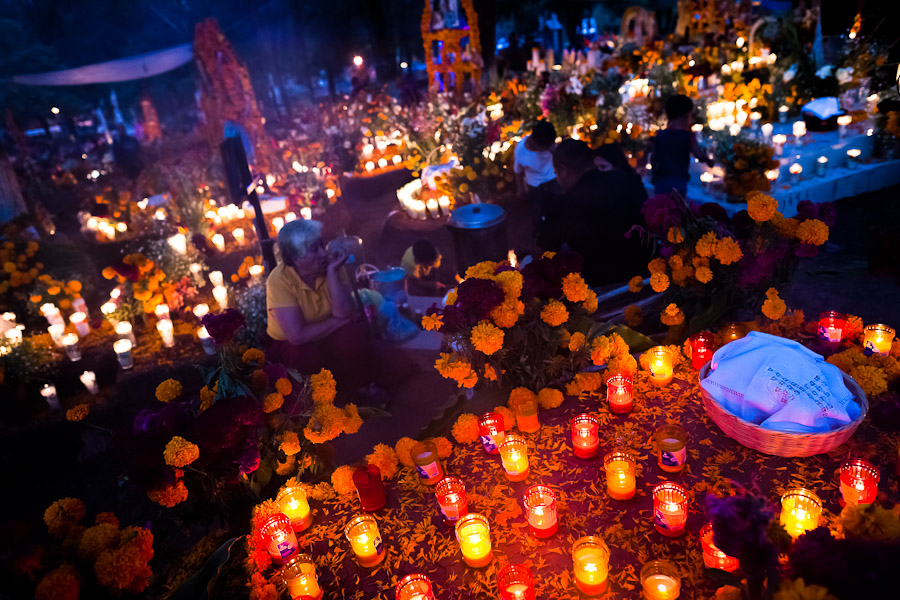 Mexican family members light candles and pray at the cemetery to honor their deceased relatives during the Day of the Dead celebration in Tzintzuntzan, Michoacán, Mexico.