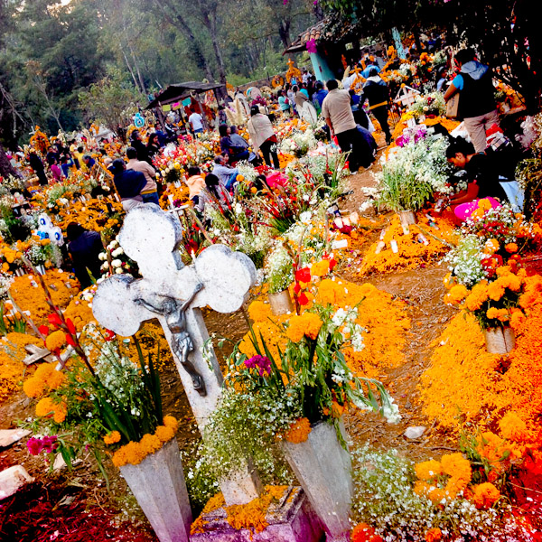 Mexican people gather around the graves, covered by marigold flowers, honouring their deceased relatives during the ritual celebration of the Day of the Dead (Día de Muertos) at the cemetery of Tzurumútaro, Michoacán, Mexico.