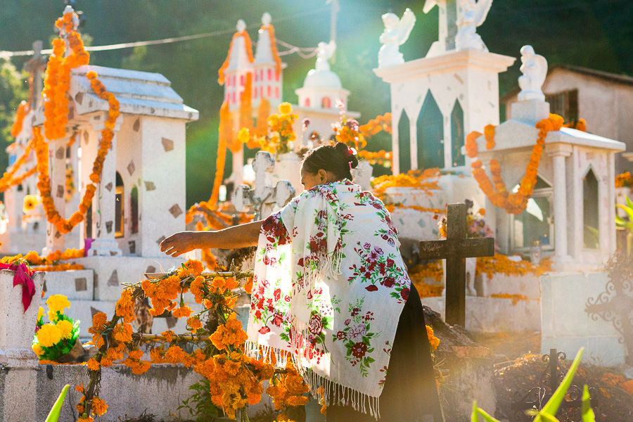 A Mixtec indigenous woman decorates a tomb during the Day of Dead celebrations in Xalpatlahuac, Guerrero, Mexico.