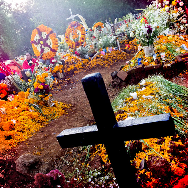 Graves covered by marigold flowers, gifts and candles, in honor of the deceased, are seen during the ritual celebration of the Day of the Dead (Día de Muertos) at the cemetery of Tzurumútaro, Michoacán, Mexico.
