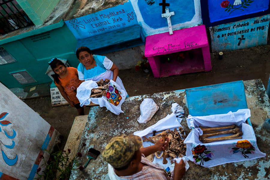 Mayan peasants take care of dried-up bones of a deceased family member during the bone cleansing ritual at the cemetery in Pomuch, Mexico.