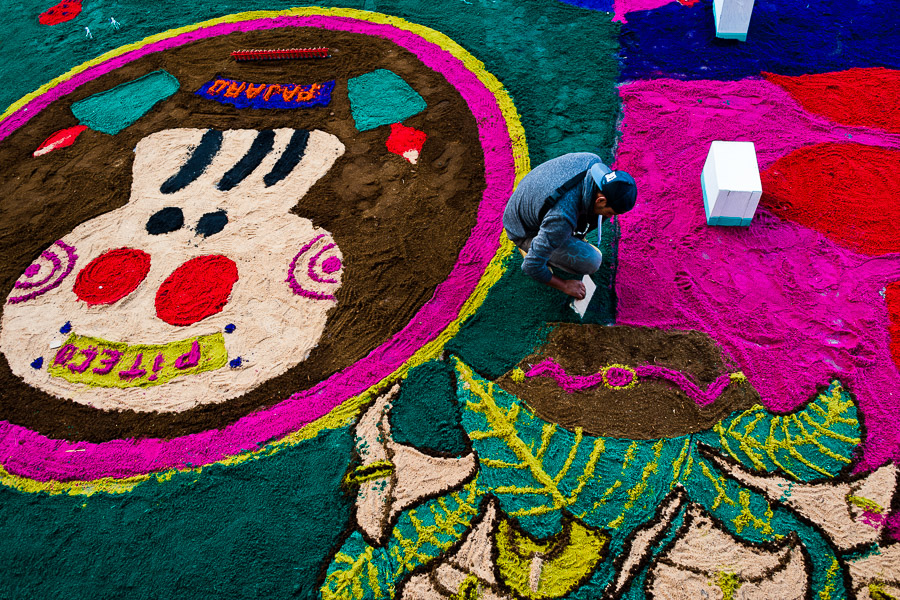 A Mexican boy creates a colorful sawdust carpet, displaying skull (Calavera), during the Day of the Dead festivities in San Juan Ixtayopan, Mexico.
