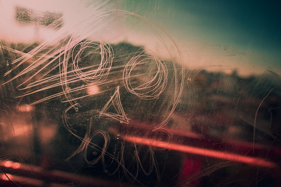 A skull icon is seen scratched into the glass window of a subway car passing in the outskirts of Mexico City, Mexico.