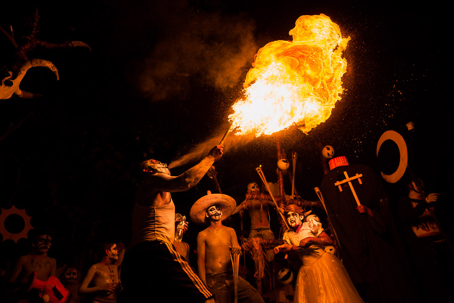 A young Salvadoran man spits fire as he performs during the La Calabiuza parade at the Day of the dead celebration in Tonacatepeque, El Salvador.
