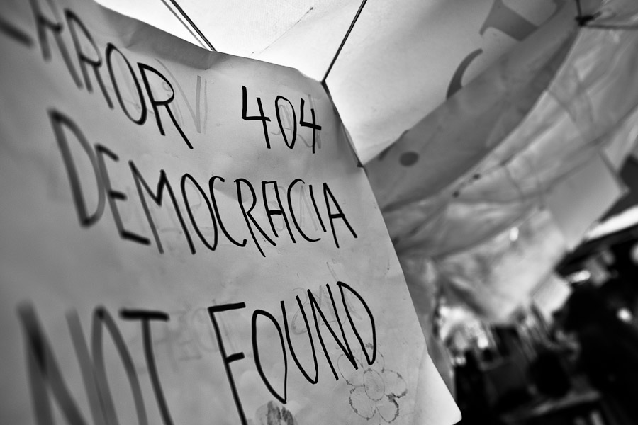 A political banner (‘Error 404, Democracy not found’) hangs inside the protest camp on Puerta del Sol square, Madrid, Spain.