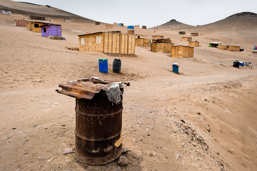 A rusty barrel, used for water storage, is seen on the dusty hillside of Pachacútec, a desert suburb of Lima, Peru.