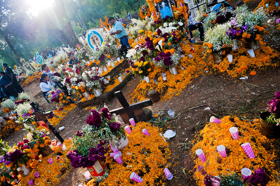 Mexican families gather at the cemetery, bringing flowers and food offerings, to honor their deceased relatives during the Day of the Dead festivities in Tzurumútaro, Michoacán, Mexico.