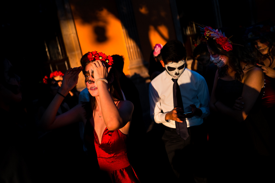 Young Mexican women, dressed as La Catrina, and a young Mexican man, dressed as Catrín, take part in the Day of the Dead festivities in Morelia, Michoacán, Mexico.