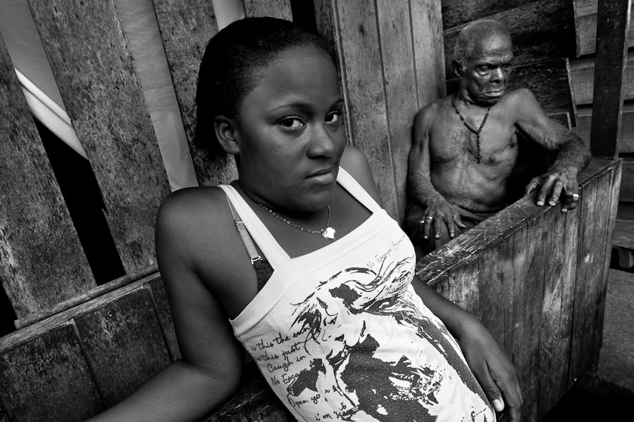 A displaced girl stands in front of the wooden house inside the poor neigbourhood of Tumaco, Colombia.