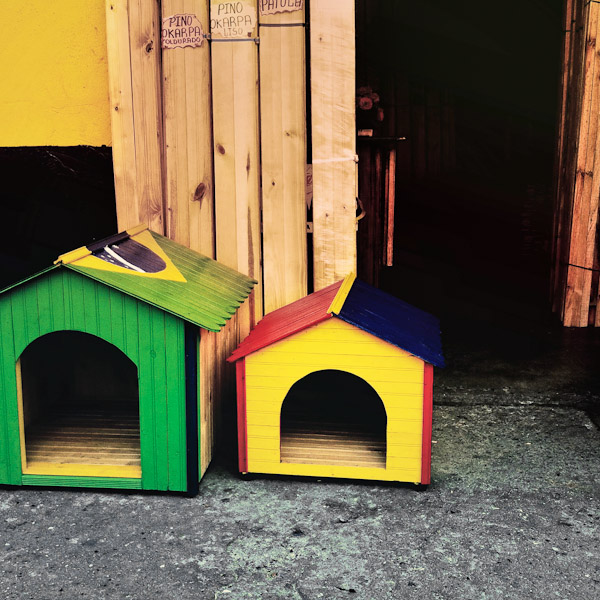 Dog houses, painted in national flag colors of Brazil and Colombia, are seen for sale on the street in Cali, Colombia.