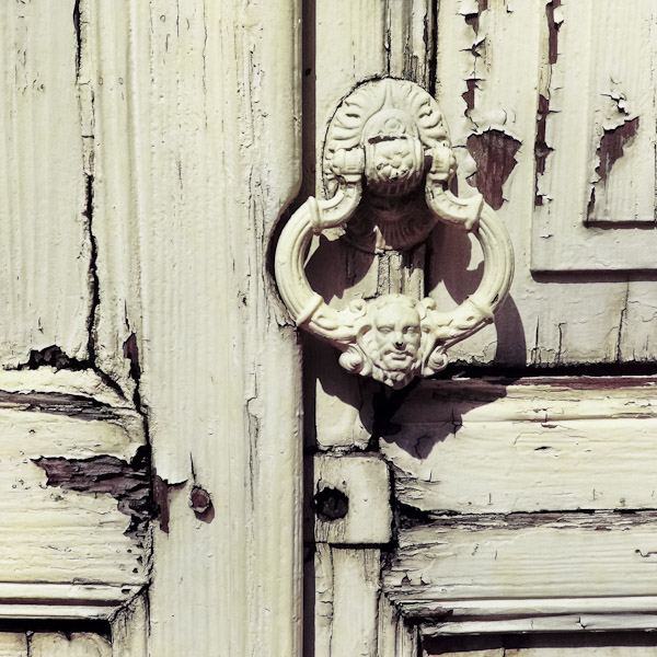 An antique door knocker is seen hung on the rotten wooden door of a Spanish colonial house in Morelia, Mexico.