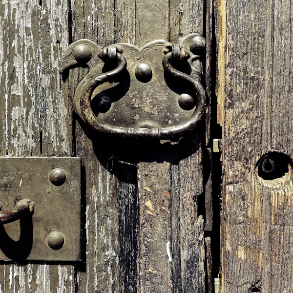 An antique door knocker is seen hung on the rotten wooden door of a Spanish colonial house in Morelia, Mexico.