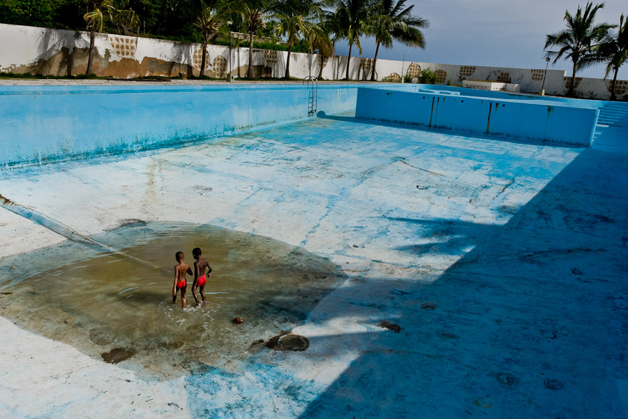 Cuban kids playing a game in the bottom of the old drained swimming pool in the small costal village of Siboney, Cuba.