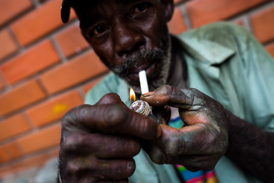 A Colombian homeless man smokes a pipe loaded by ‘bazuco’ (a raw cocaine paste) during collecting of recyclable trash on the street of Medellín, Colombia.