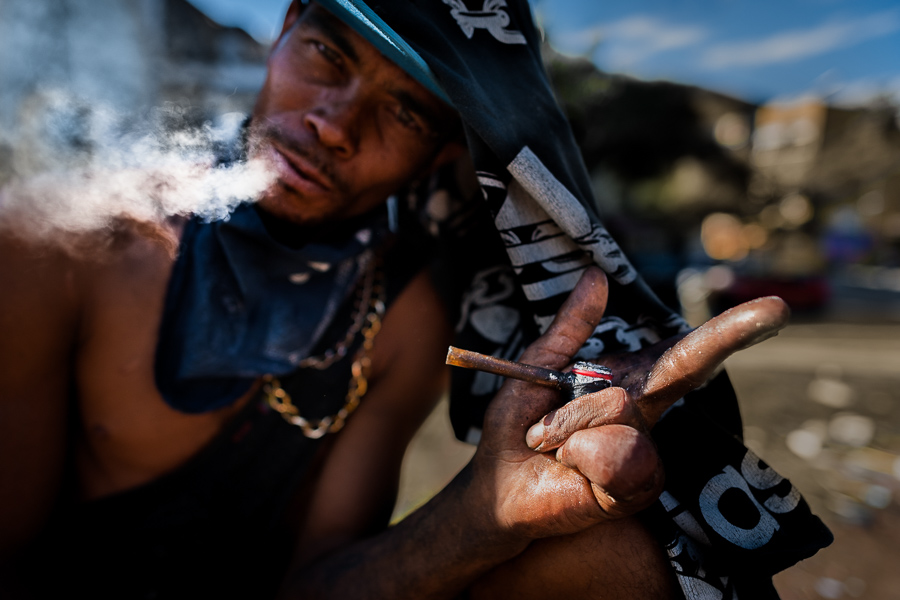 A Colombian man blows out the smoke after having smoked “bazuco” (a raw cocaine paste) in the street in Medellín, Colombia.