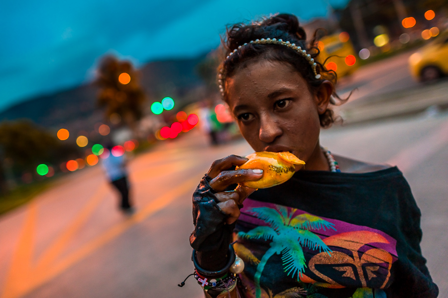 A Colombian drug consumer eats mango on the street near an area called “Bronx” in the center of Medellín, Colombia.