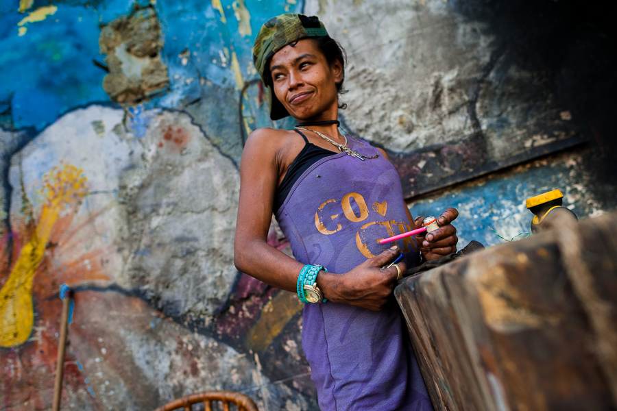 A young Colombian woman smokes “basuco” (a raw cocaine paste) in the street of “El Bronx” in Medellín, Colombia.