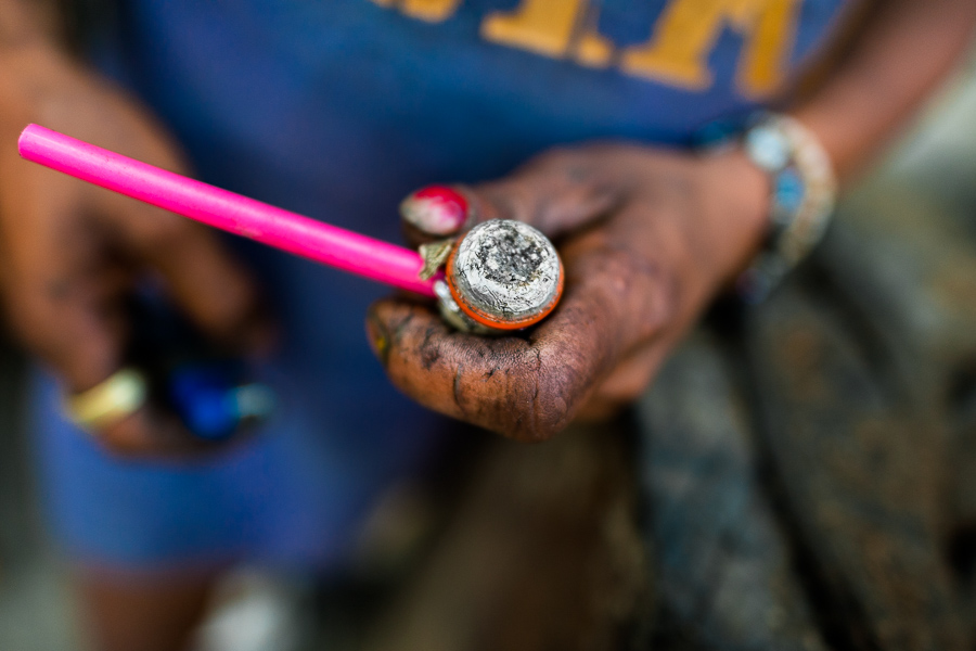 A hand of a Colombian woman, holding a pipe loaded with “basuco” (a raw cocaine paste), is seen in the street of “El Bronx” in Medellín, Colombia.