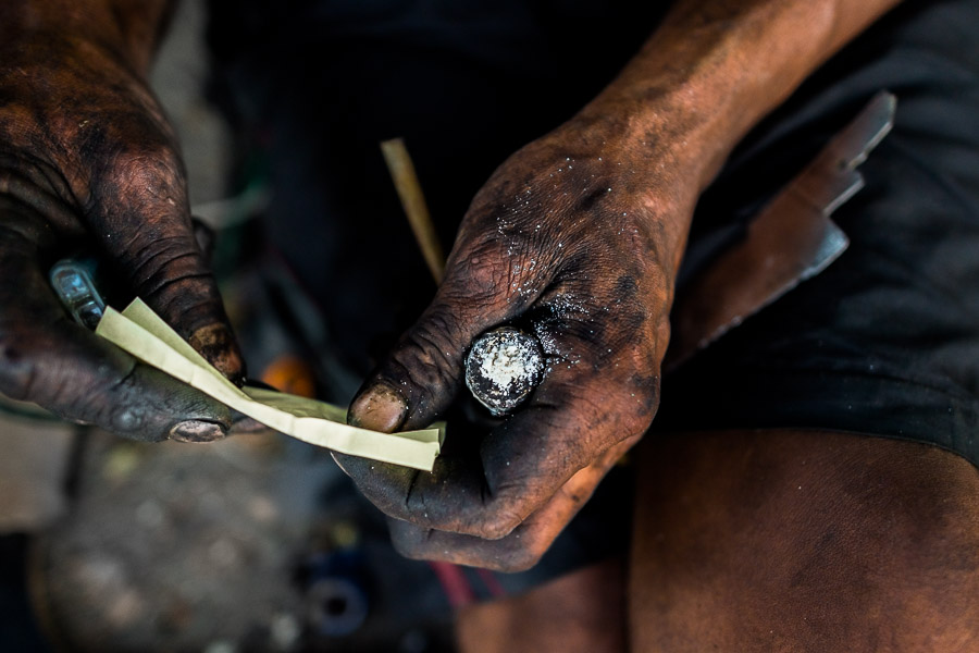 A hand of a Colombian drug user, holding a pipe loaded with ‘bazuco’ (a raw cocaine paste), is seen on the street of ‘Bronx’, in Medellín, Colombia.