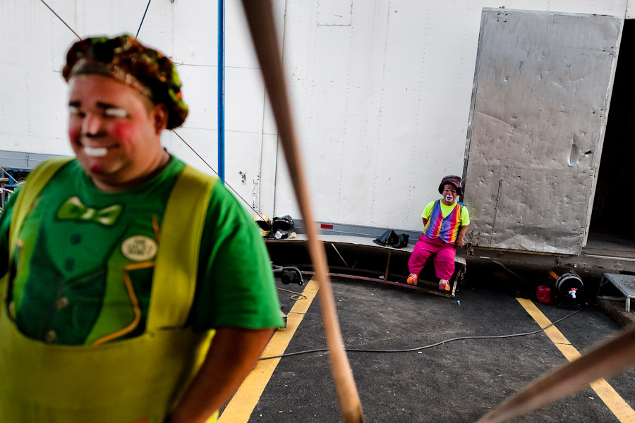 A dwarf clown takes a rest, together with his clown collegue, in the backstage of Circus Renato, in San Salvador, El Salvador.