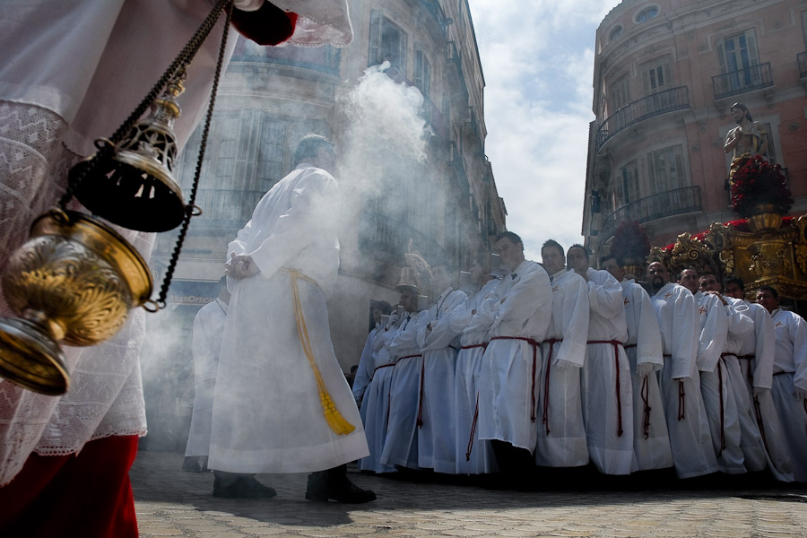 On Easter Sunday morning the frankincense smoke flows out of the brass censer and fills the streets of Malaga with heavy aroma.