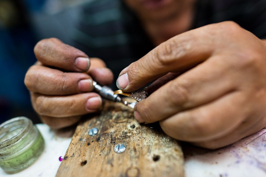 A Colombian jeweler works on a ring in the jewelry workshop in Bogota, Colombia.