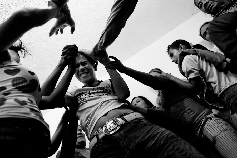 A Colombian boy, held by his fellow believers, screams of pain while being allegedly possessed by demons during the exorcism ritual performed at a house church in Bogota, Colombia.
