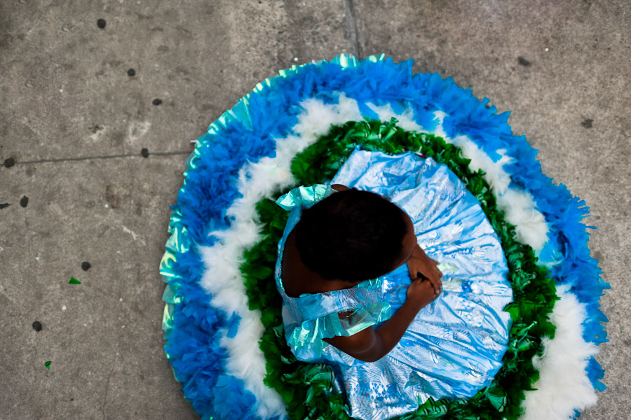 A Brazilian girl, wearing a large colorful costume, takes part in the Carnival parade in the favela of Rocinha, Rio de Janeiro, Brazil.