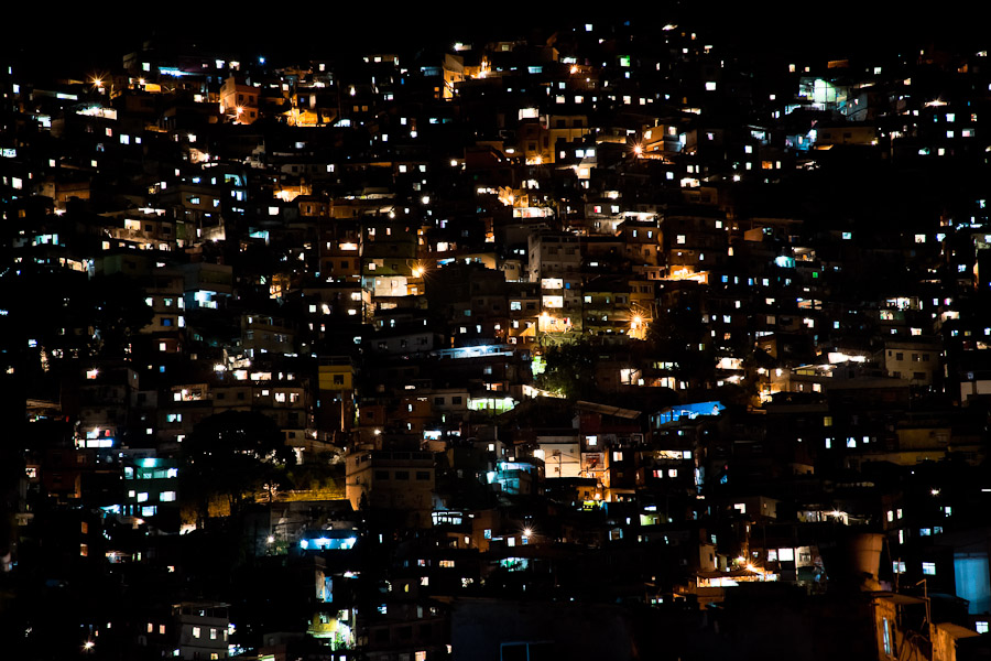 City lights seen on a steep hillside in the favela of Rocinha, Rio de Janeiro, Rio de Janeiro, Brazil.