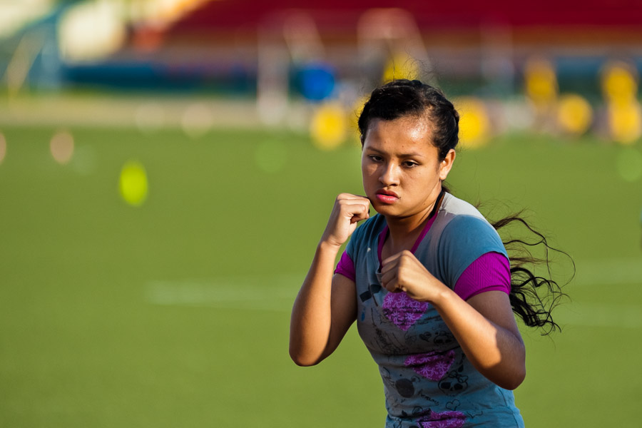 A young Peruvian girl practices shadowboxing while training in the outdoor boxing school at the Telmo Carbajo stadium in Callao, Peru.