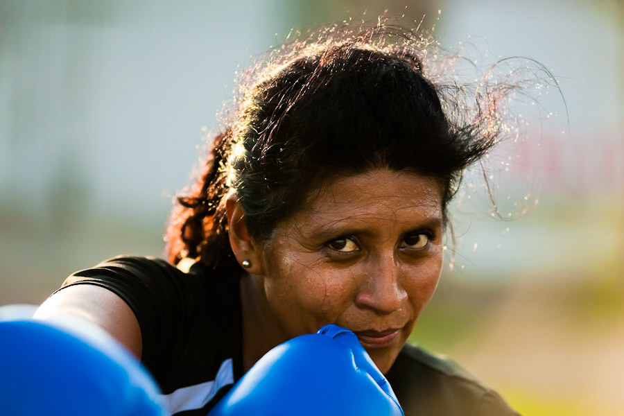 A Peruvian woman practices punching while training in the outdoor boxing school at the Telmo Carbajo stadium in Callao, Peru.